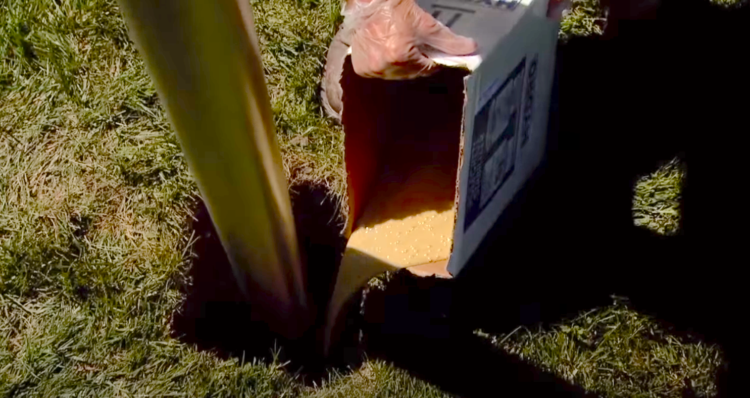 This is a demonstration of a sign post being set in the ground using BMK Product's Polecrete Stabilizer